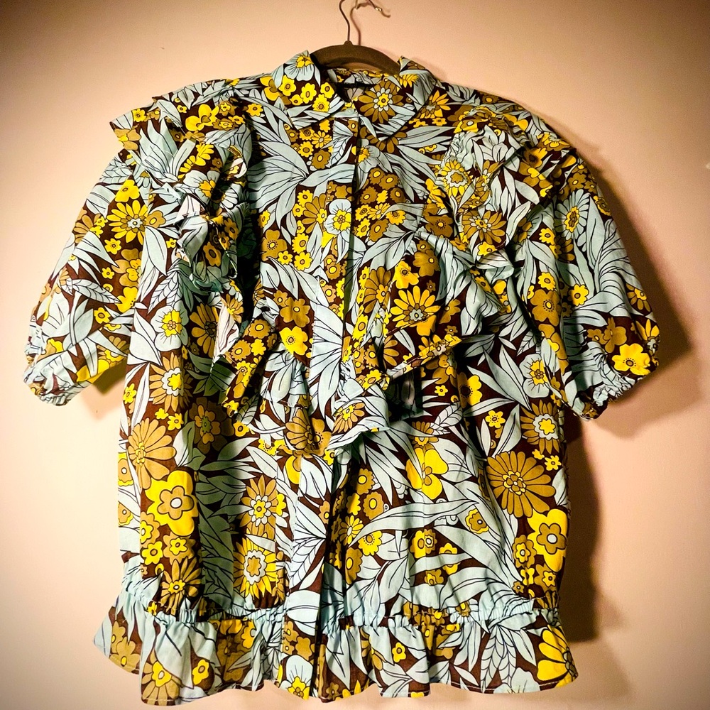 Ruffle, powerful, floral, adventurous blouse.